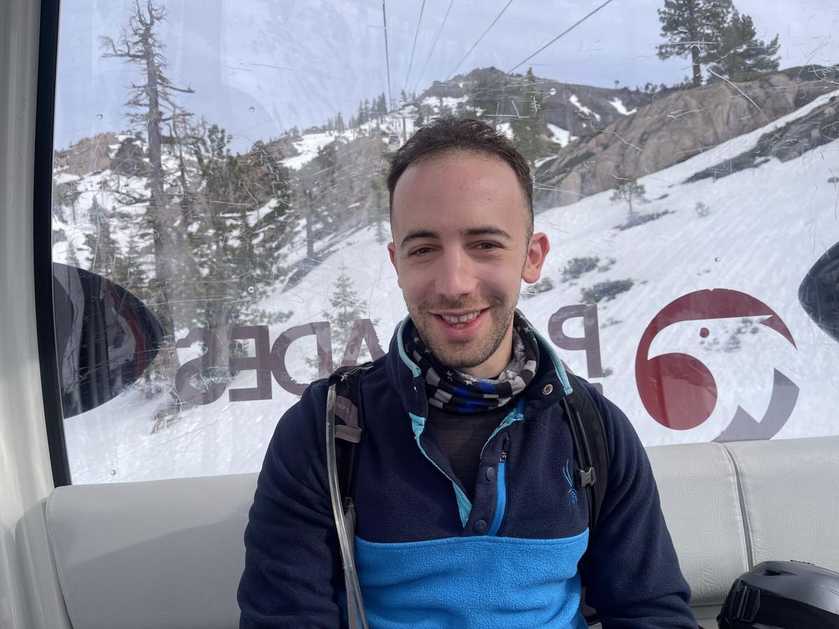 Jonathan Mares in a gondola with snowy mountain background